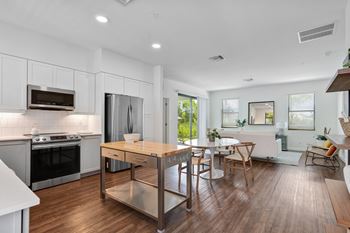 an open kitchen and dining room with a table and chairs at Odyssey, Florida